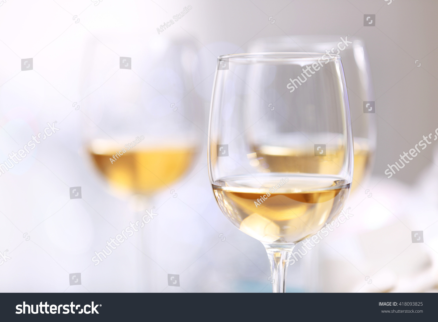 stock-photo-wineglasses-on-light-blurred-background-418093825
